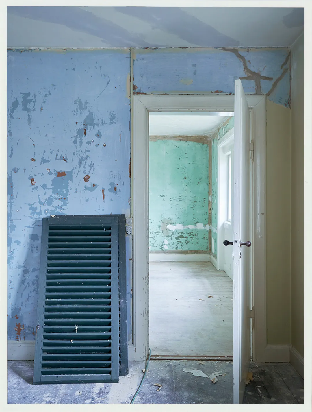 A blue door and adjoining room during restoration at Villa Hesnæs.