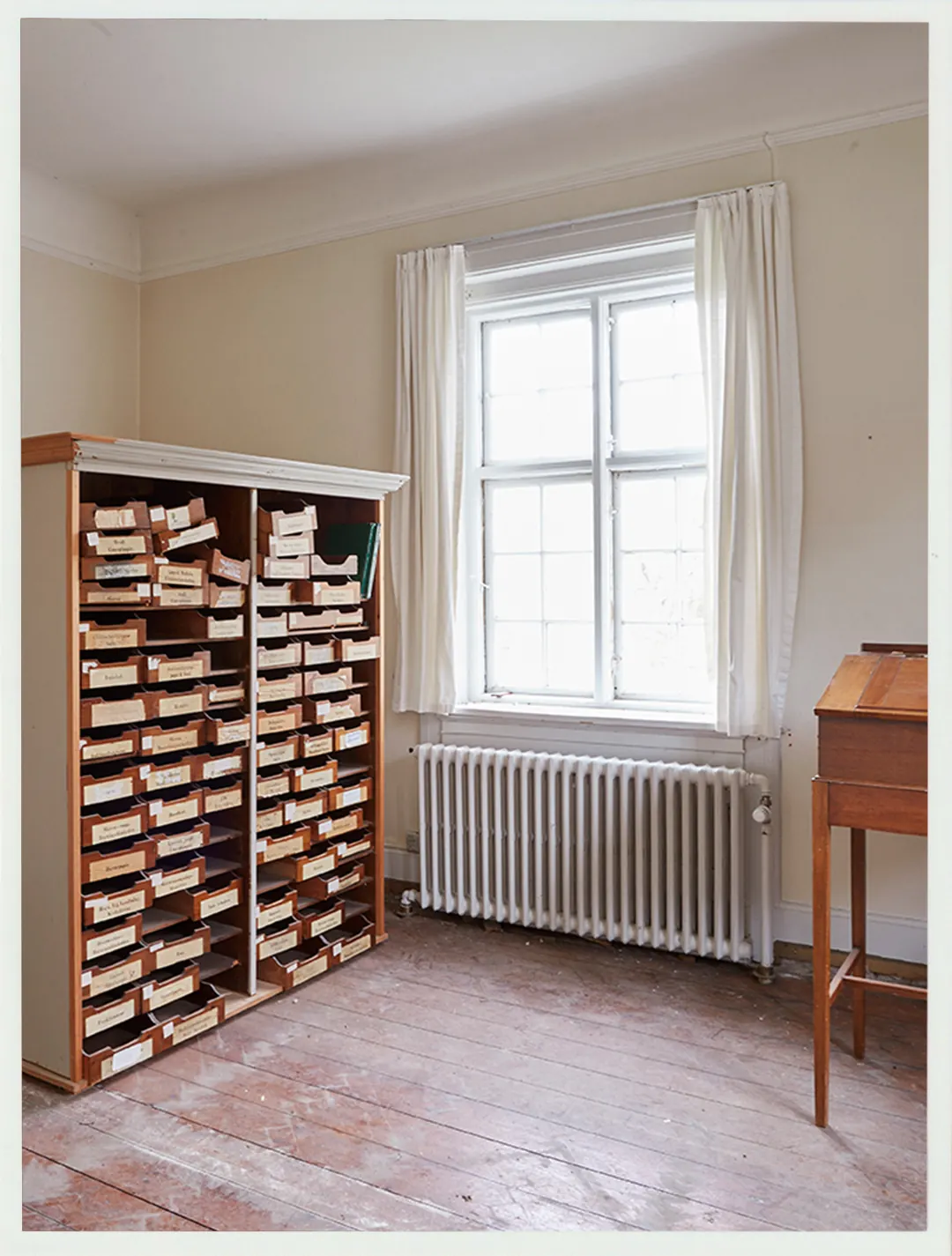 An archival cabinet beside a window during the Villa Hesnæs restoration.