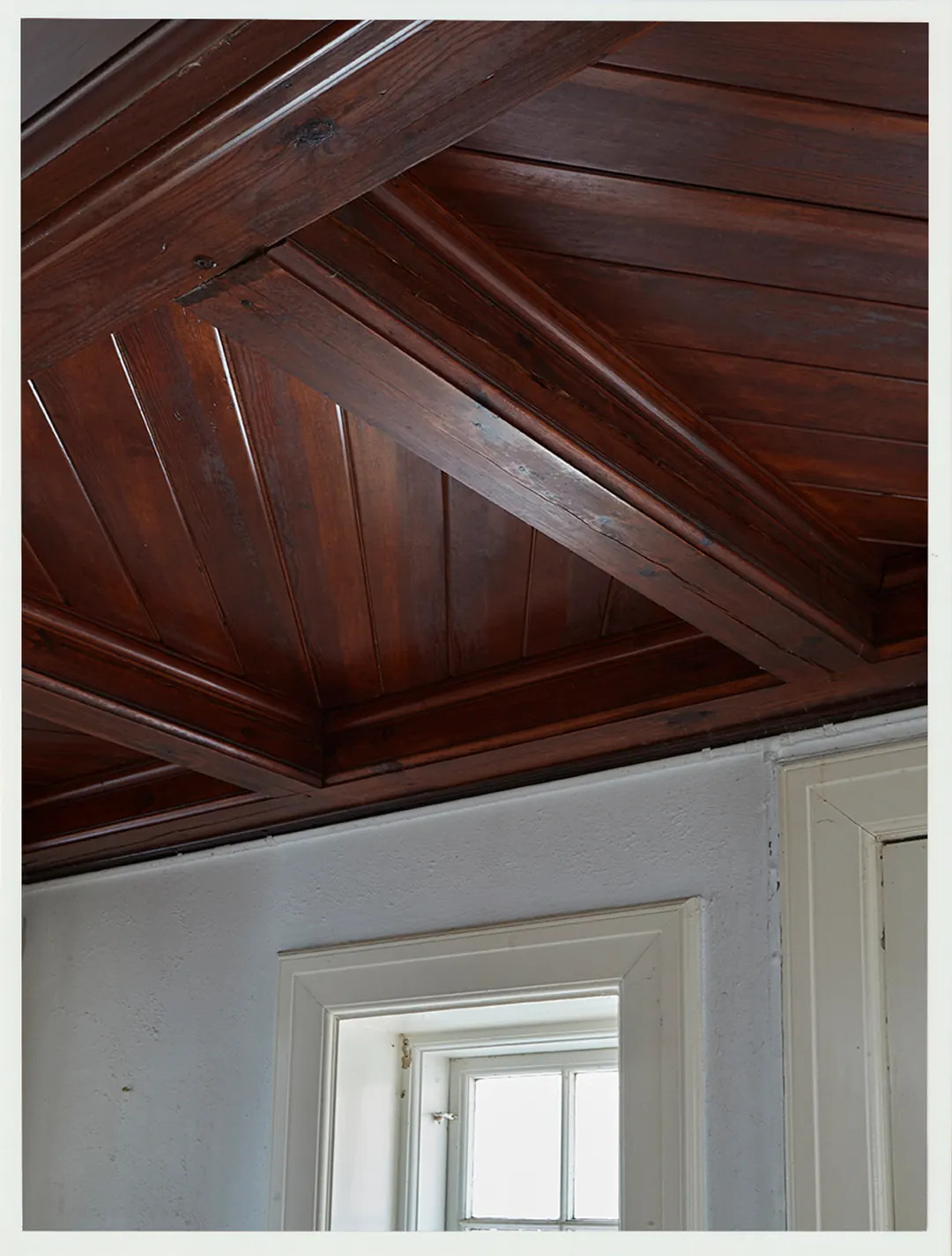 A restored dark timber ceiling detail at Villa Hesnæs.