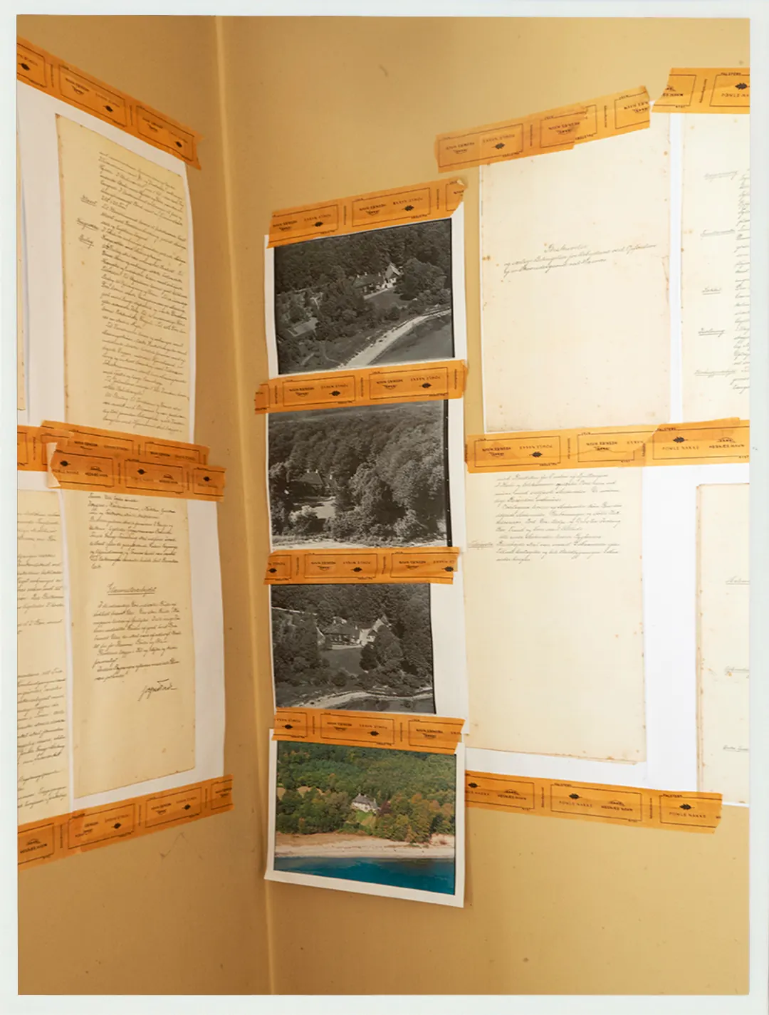 Historic notes and photos displayed on a Villa Hesnæs wall.