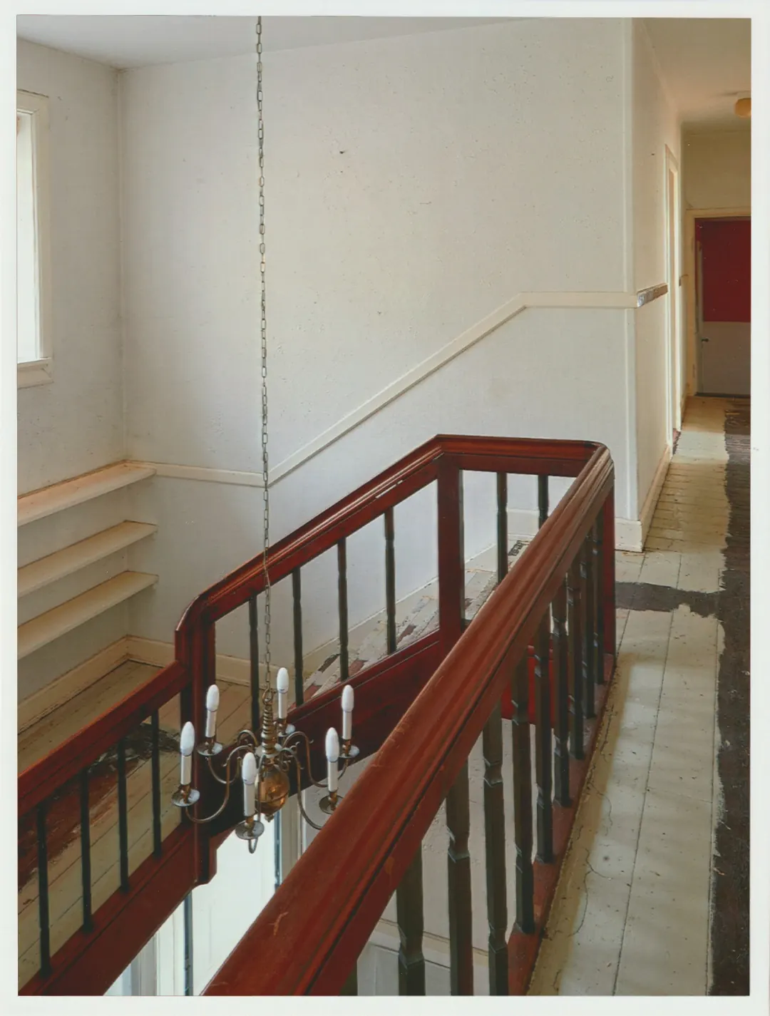 A red stair rail and landing inside Villa Hesnæs.