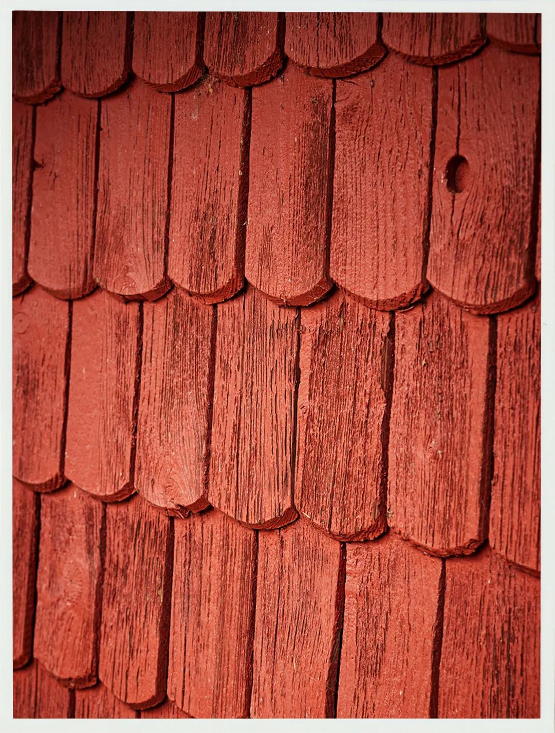 Close-up of red wooden roof tiles.