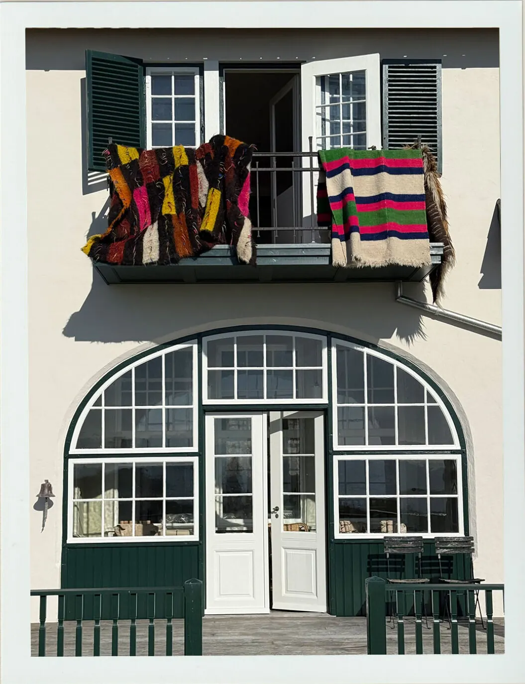 The Villa Hesnæs facade with blankets airing on the balcony.
