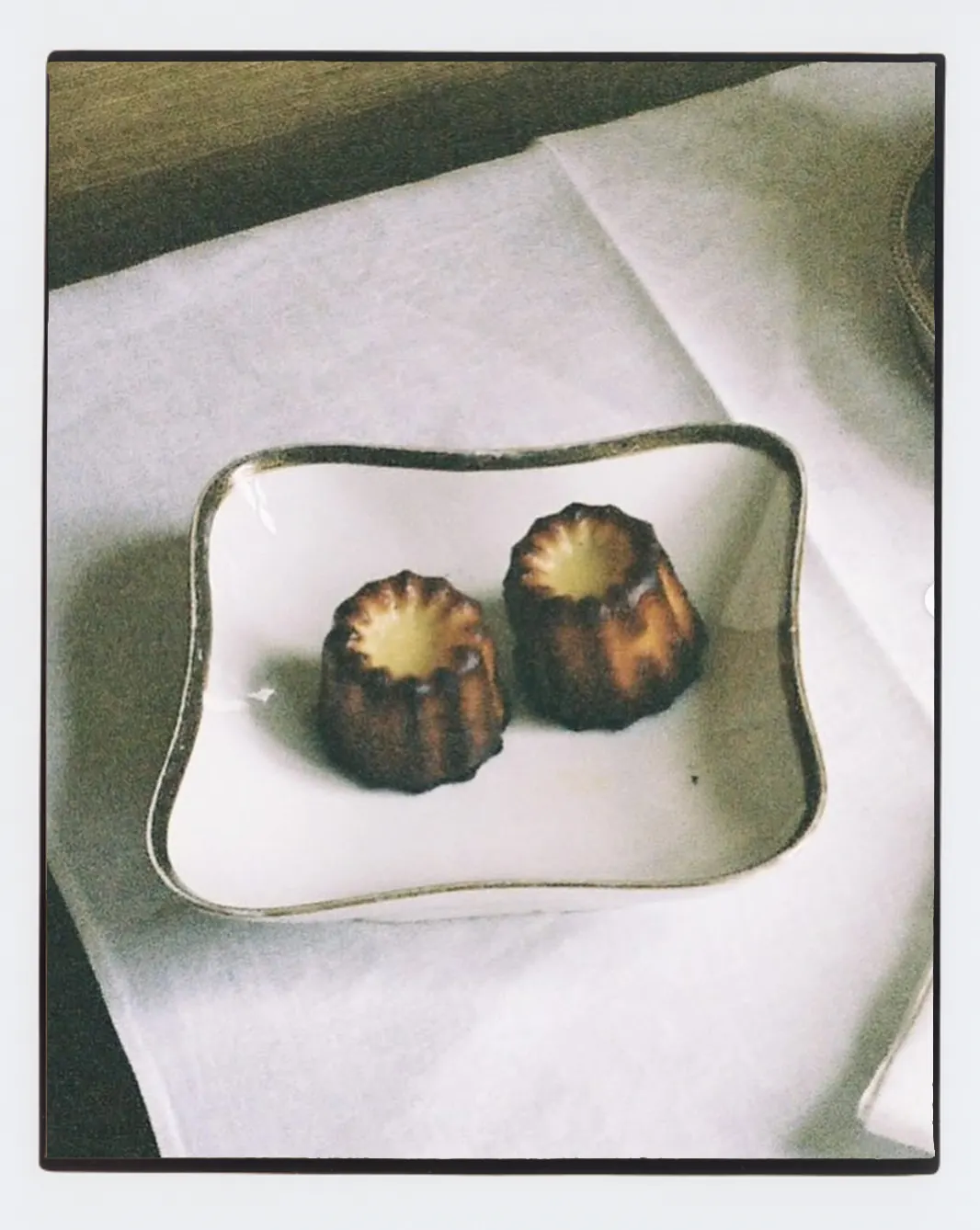 Cannelés served on a white plate.