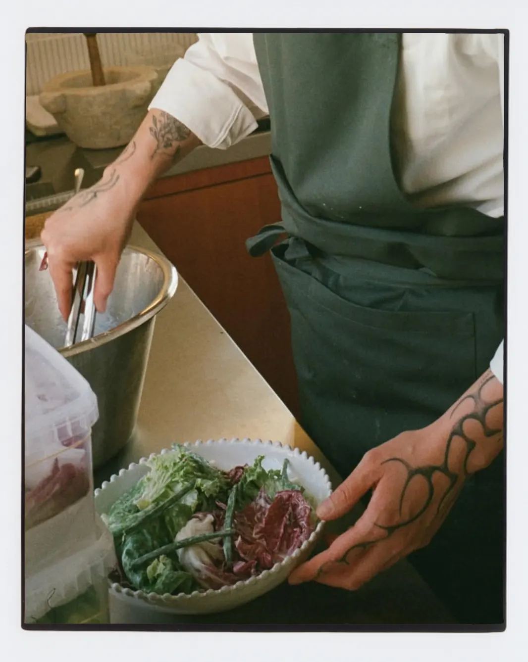 A chef prepares a dish in the Villa Hesnæs kitchen.