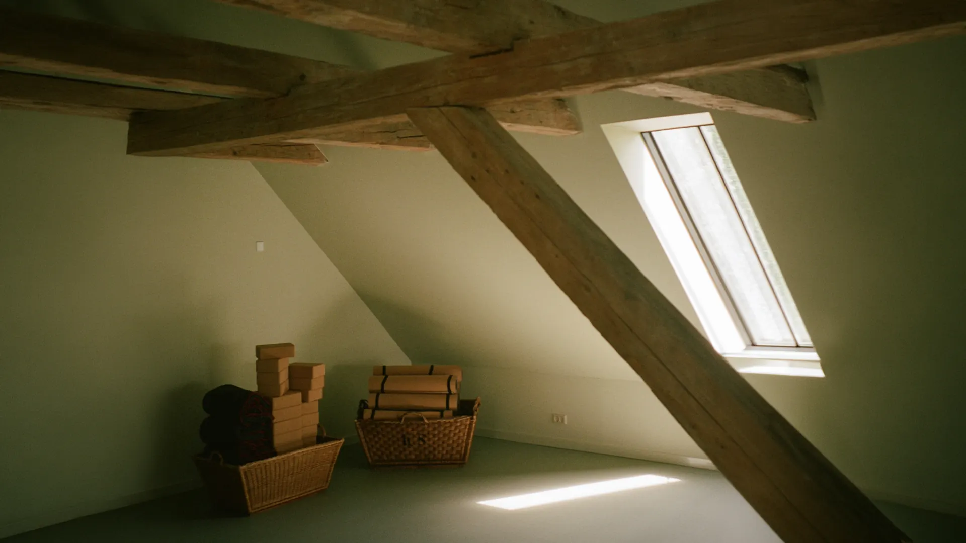 The Loft with timber beams, yoga mats, and a skylight.